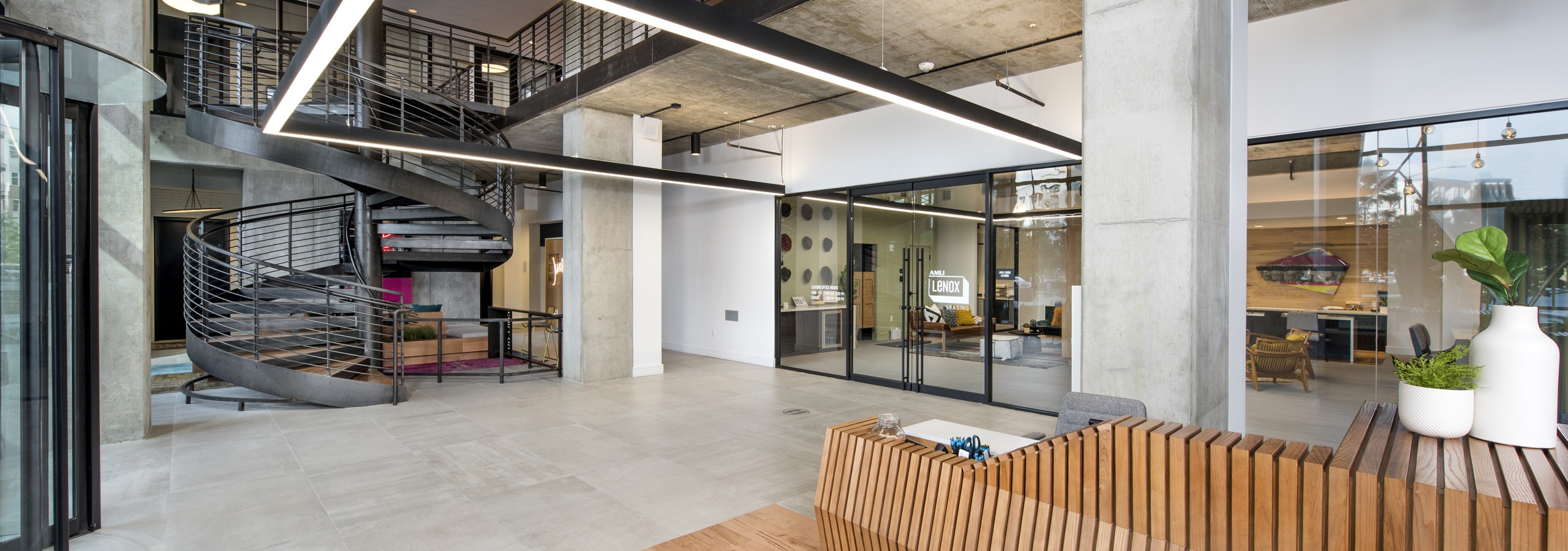 Interior view of downstairs entrance of AMLI Lenox leasing office with spiral staircase leading to the second floor