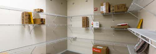 Interior view of package room at AMLI on 2nd with light walls and packages scattered along built in white shelving