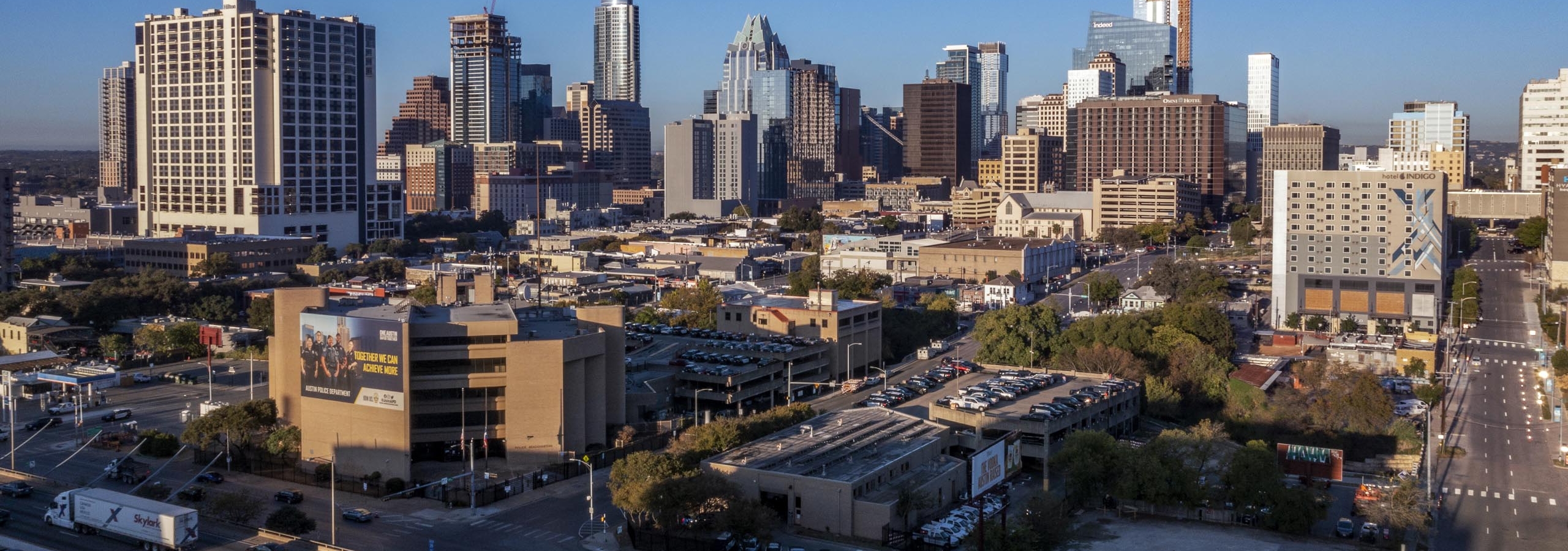 AMLI Eastside apartments view of the downtown Austin skyline at dusk including multiple skyscrapers next to a highway