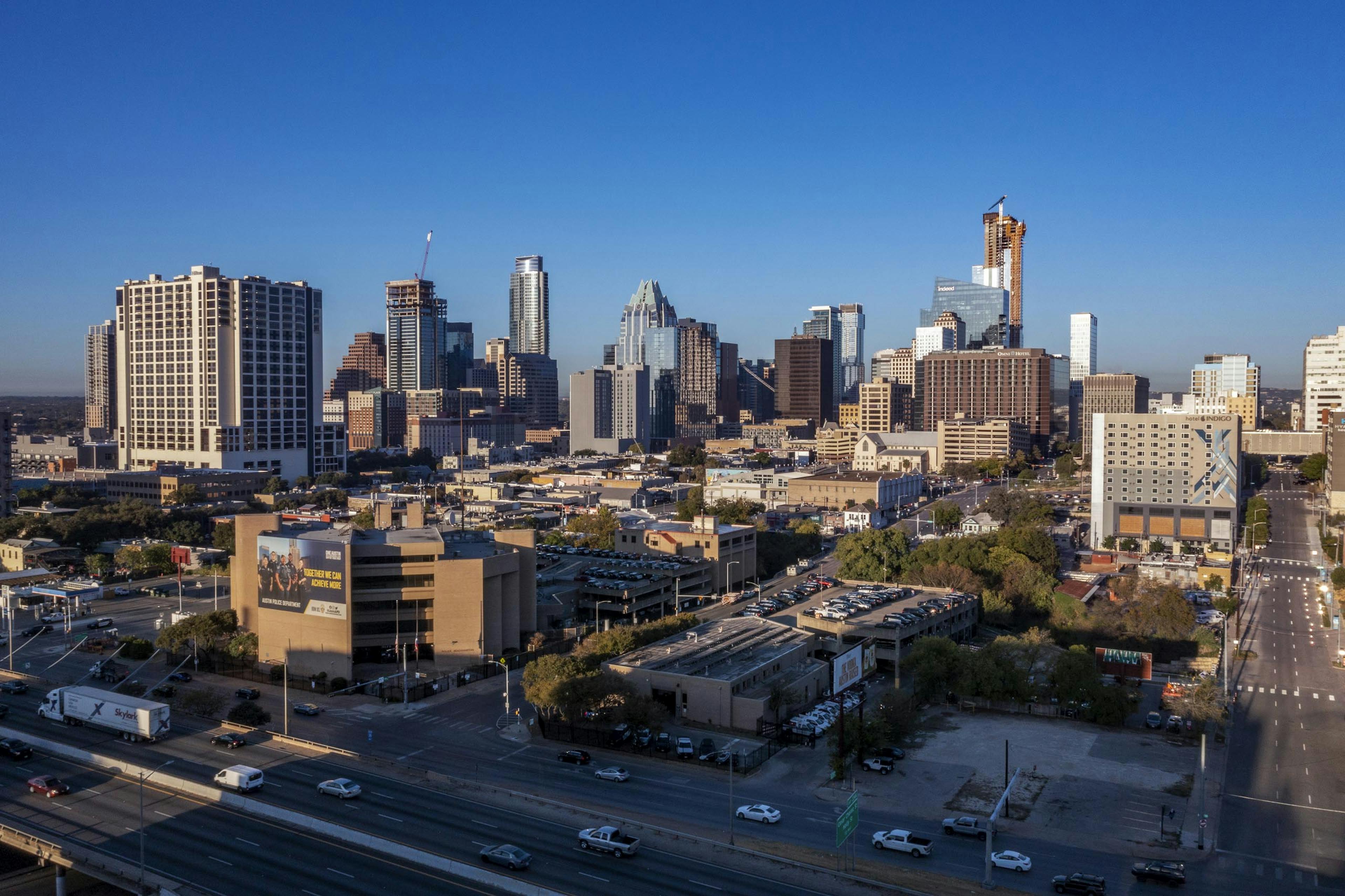 AMLI Eastside apartments view of the downtown Austin skyline at dusk including multiple skyscrapers next to a highway