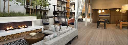 Exterior daytime view of lanai at AMLI Marina Del Rey apartments with fireplace, comfy sectional and teardrop hanging chairs