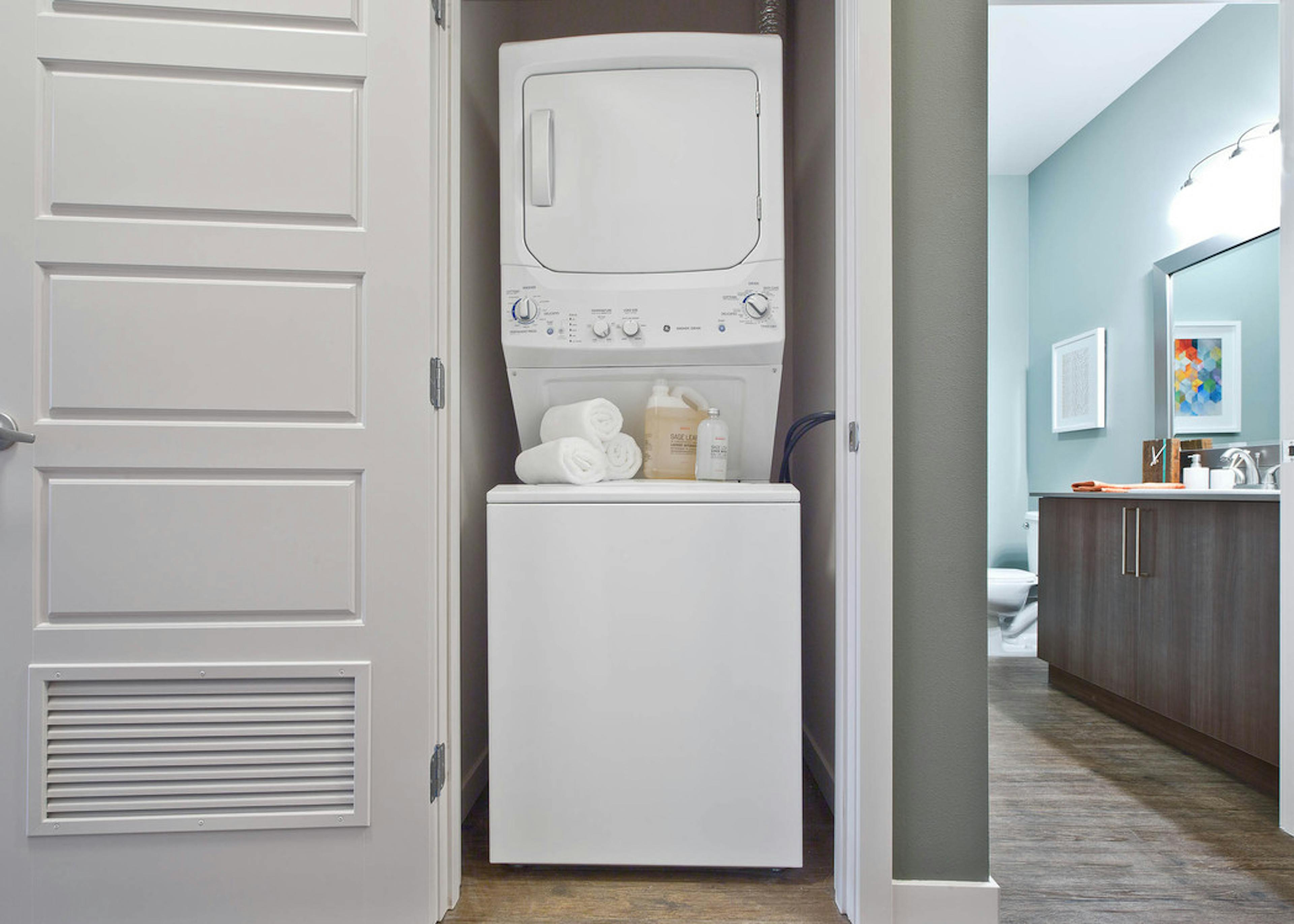 Stacked washer and dryer in a dedicated laundry closet at AMLI South Lake Union apartments