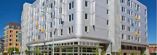 Exterior view of AMLI South Lake Union building which looks like a air stream trailer and the sidewalk