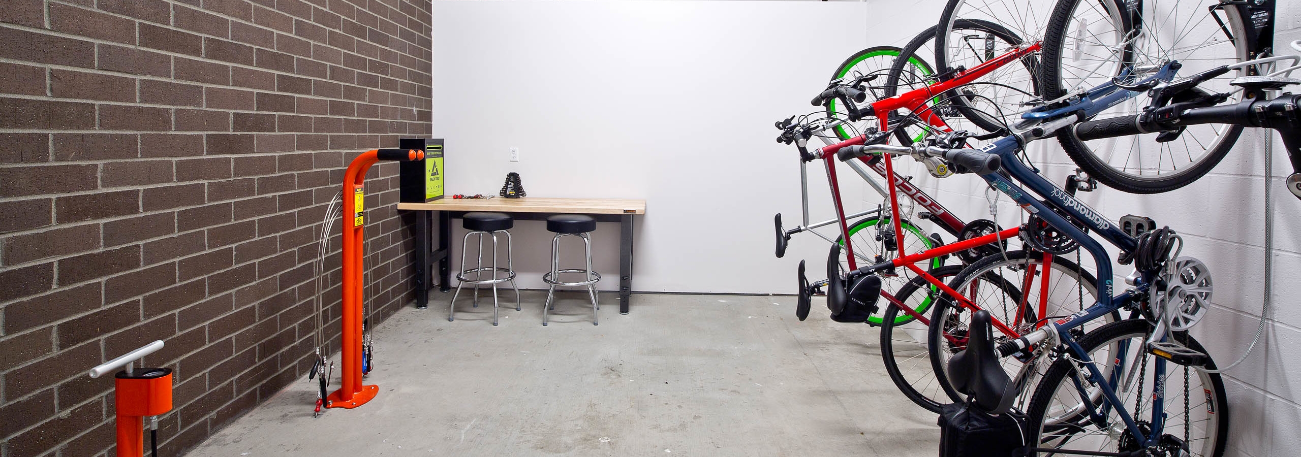 The interior bike room at AMLI South Lake Union with bike storage bike tools and seating to work on your bike