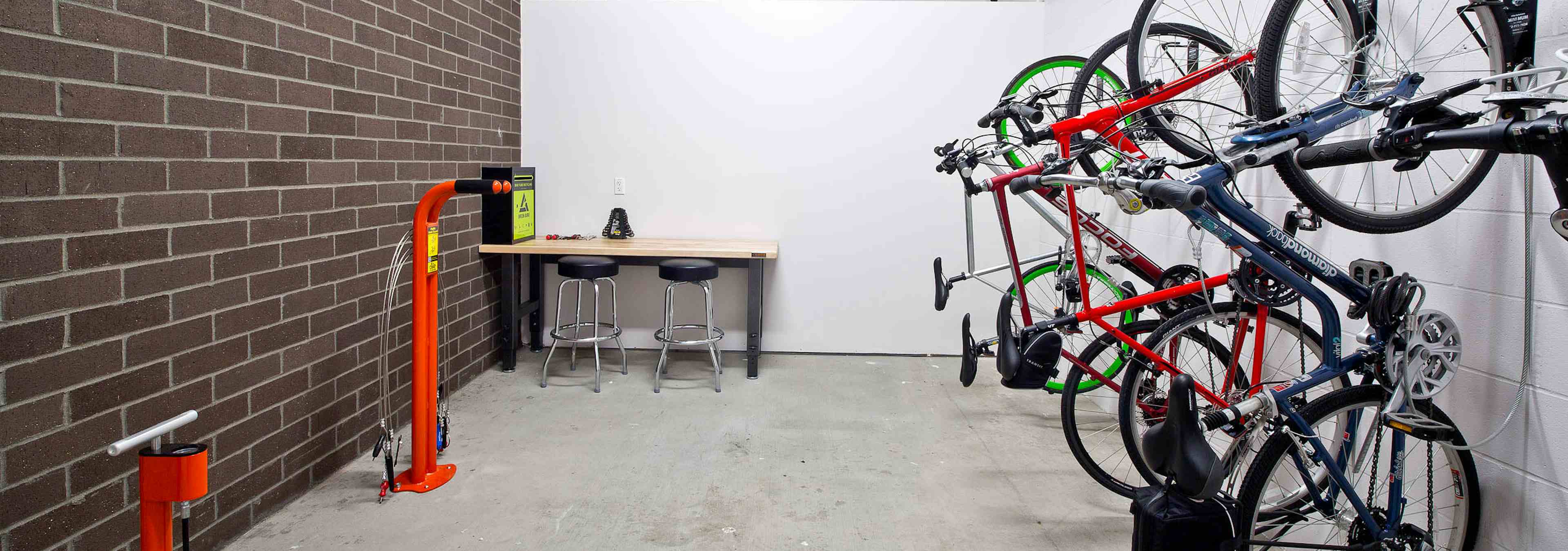 The interior bike room at AMLI South Lake Union with bike storage bike tools and seating to work on your bike 