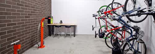 The interior bike room at AMLI South Lake Union with bike storage bike tools and seating to work on your bike