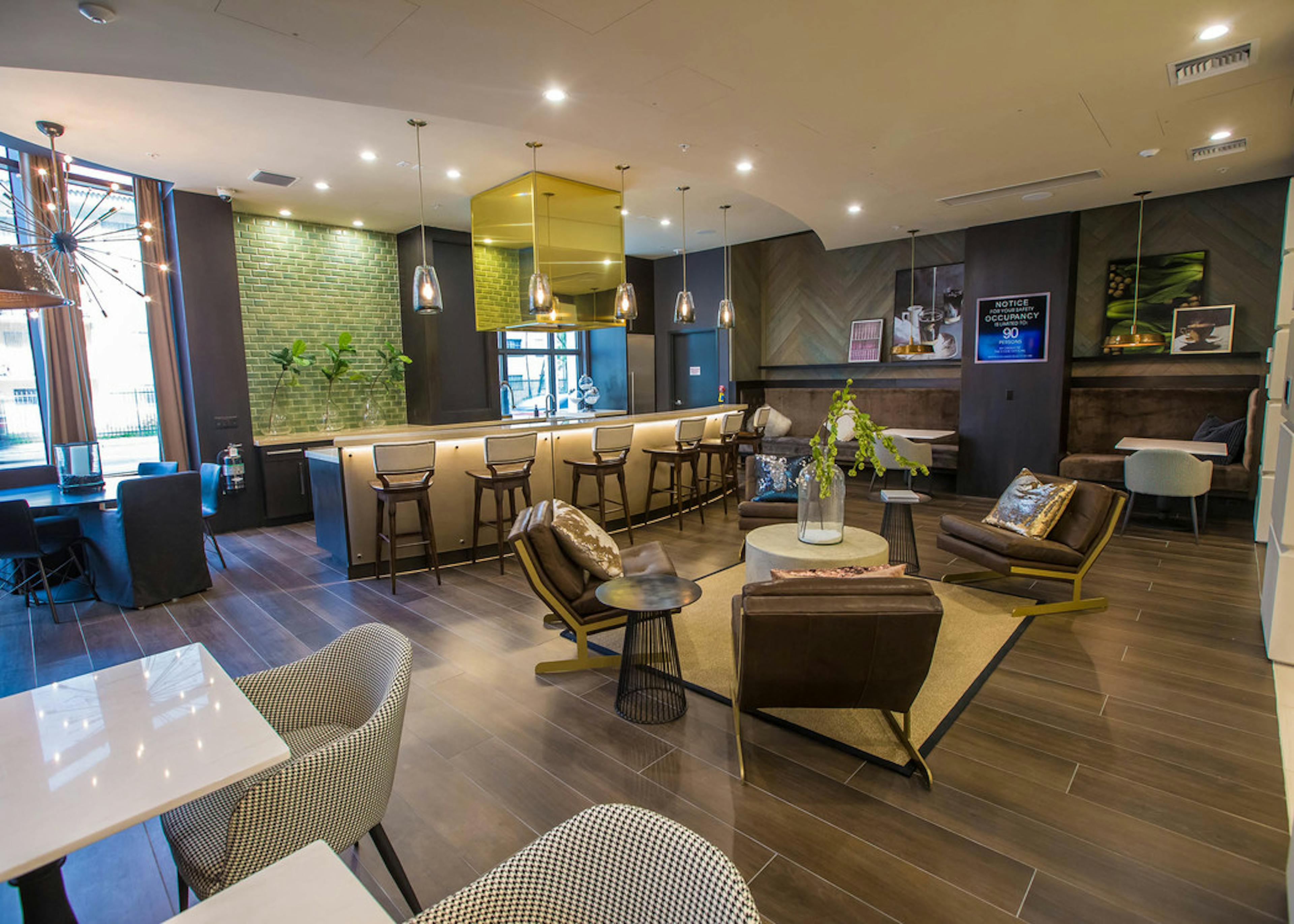 Main resident lounge at AMLI Joya with contemporary living room décor and furniture, electric fireplace and mounted TV 