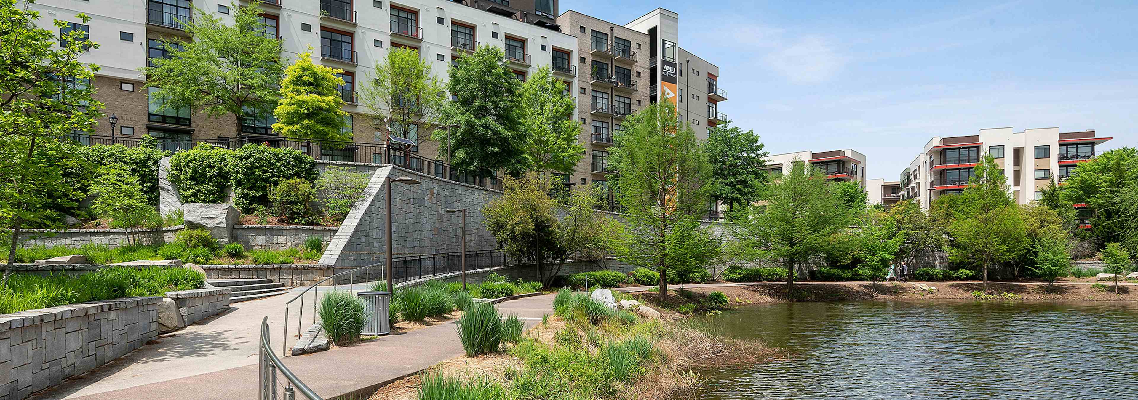 View of AMLI Old 4th Ward just steps away from Historic Old 4th Ward Park with luscious landscaping with walkways and pond