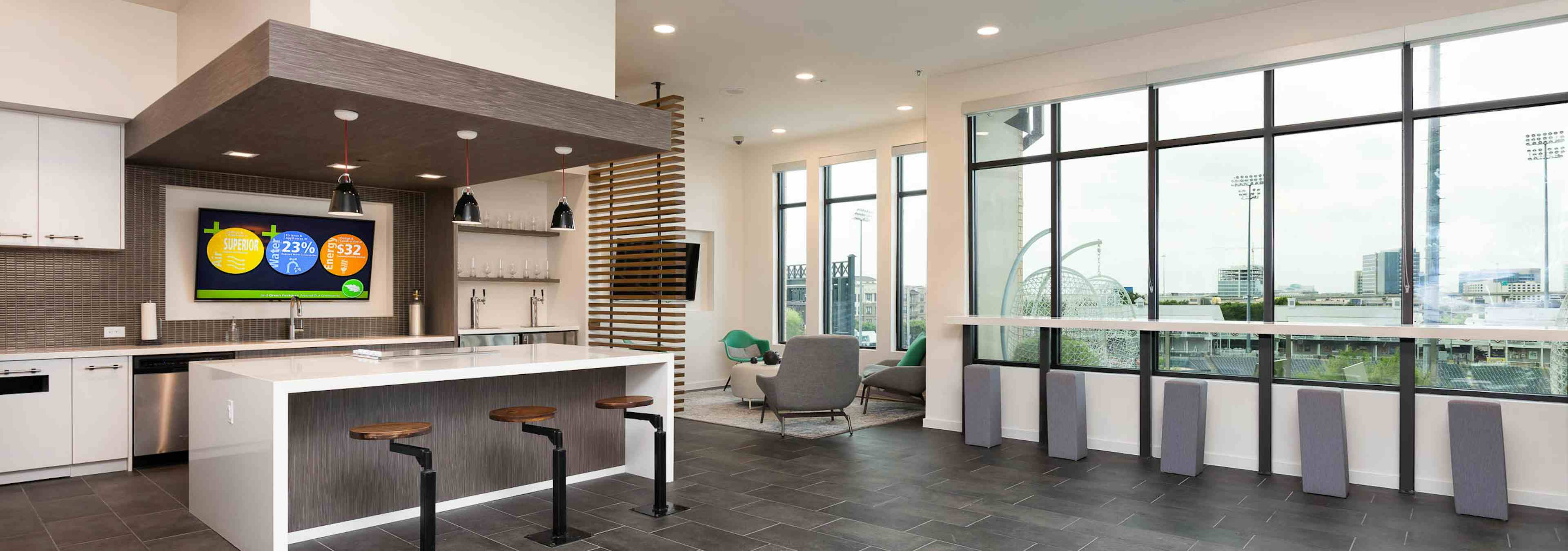 Interior of skybox suite overlooking Dr Pepper Ballpark at AMLI Frisco Crossing apartment building with serving kitchen 