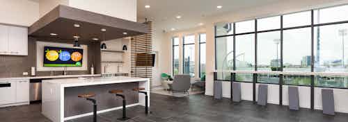 Interior of skybox suite overlooking Dr Pepper Ballpark at AMLI Frisco Crossing apartment building with serving kitchen
