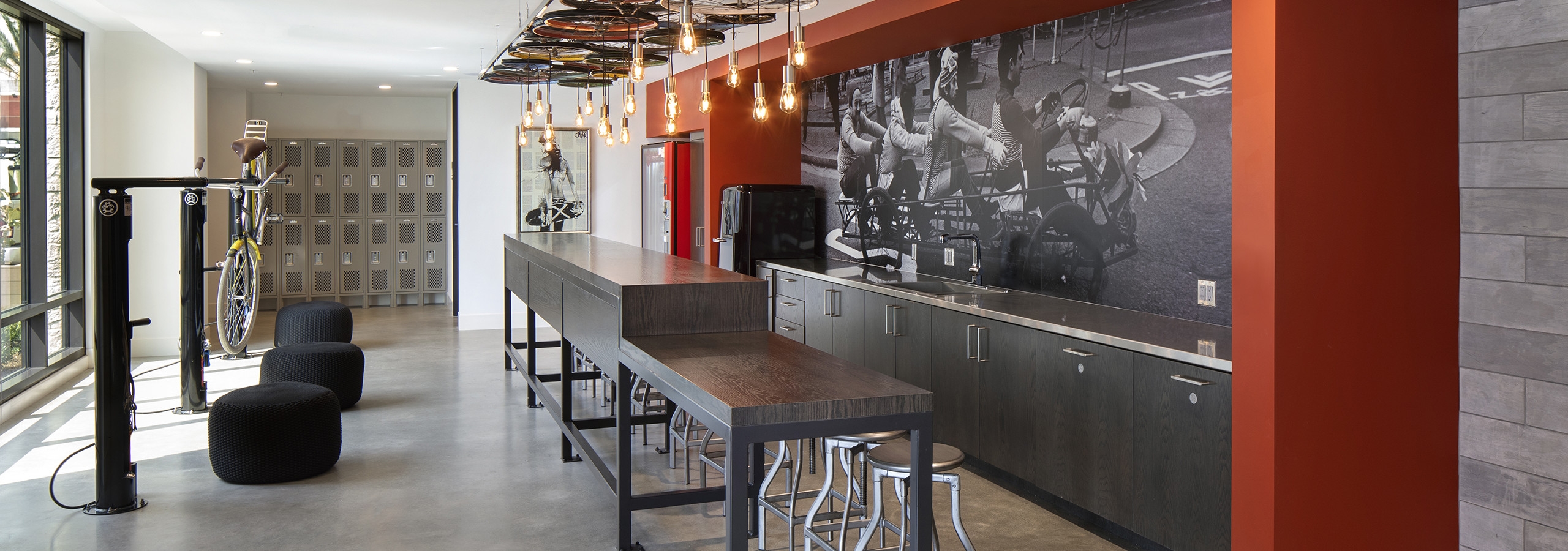 Interior of AMLI Marina Del Rey SPOKE bike repair room with tools, storage lockers and work counter and rope pendant lights