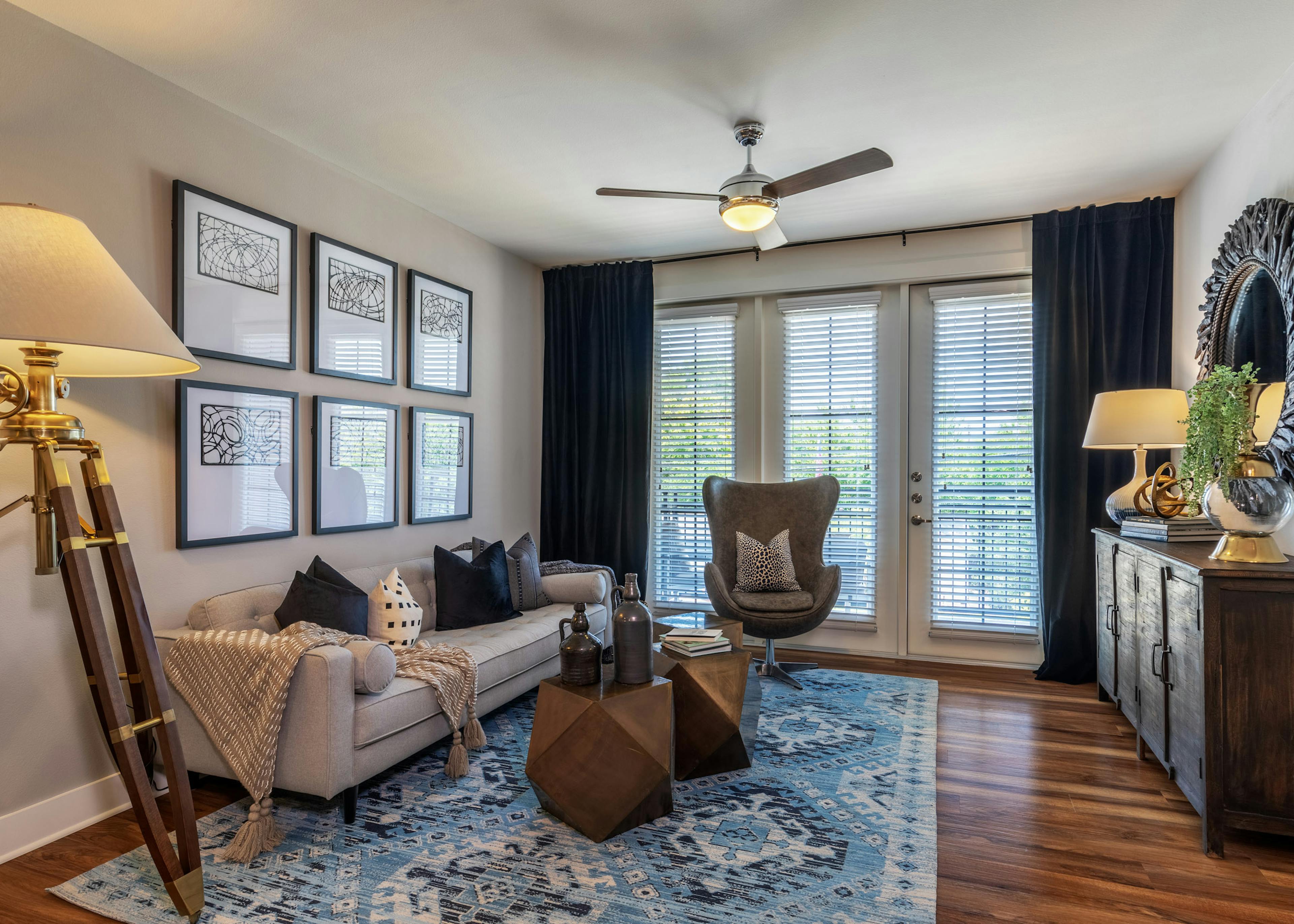 AMLI Grapevine apartment living room with hardwood floors and a private balcony and floor to ceiling windows with blinds