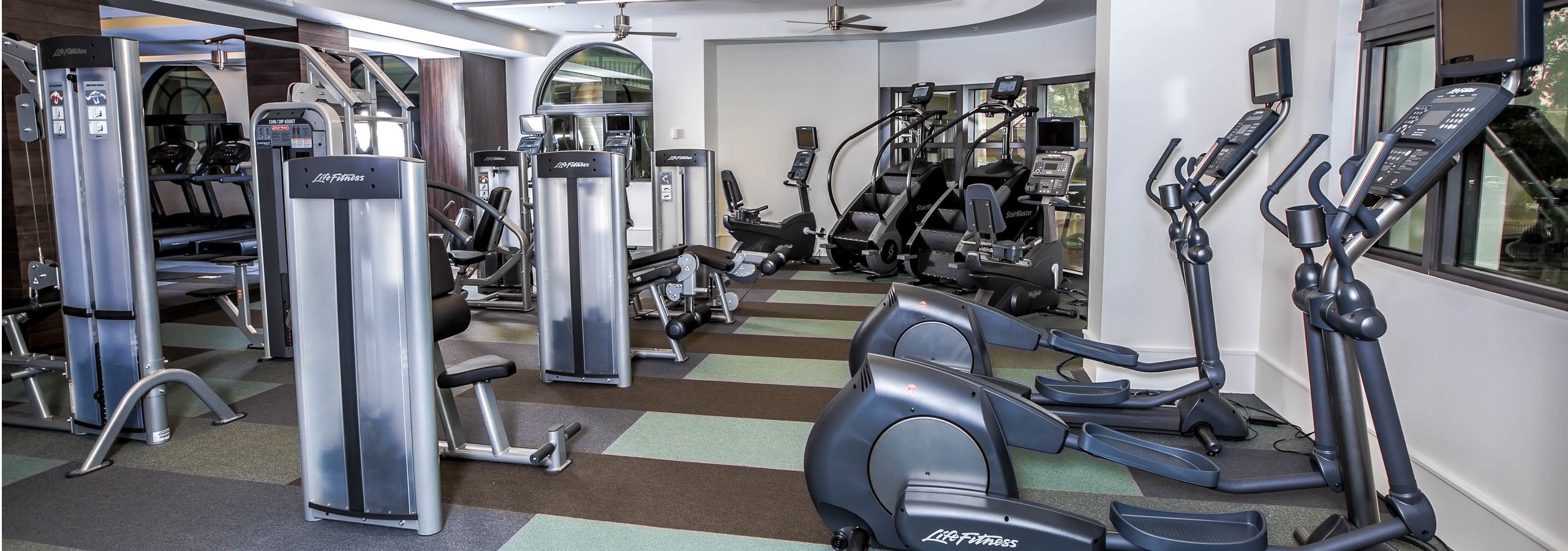 Interior of the state of the art fitness center at AMLI Joya with treadmills, weight machines and endurance equipment