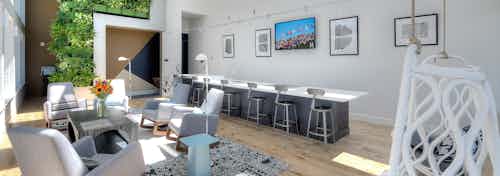 Solarium at AMLI South Lake Union apartments with large windows overlooking Lake Union and surrounding neighborhoods.
