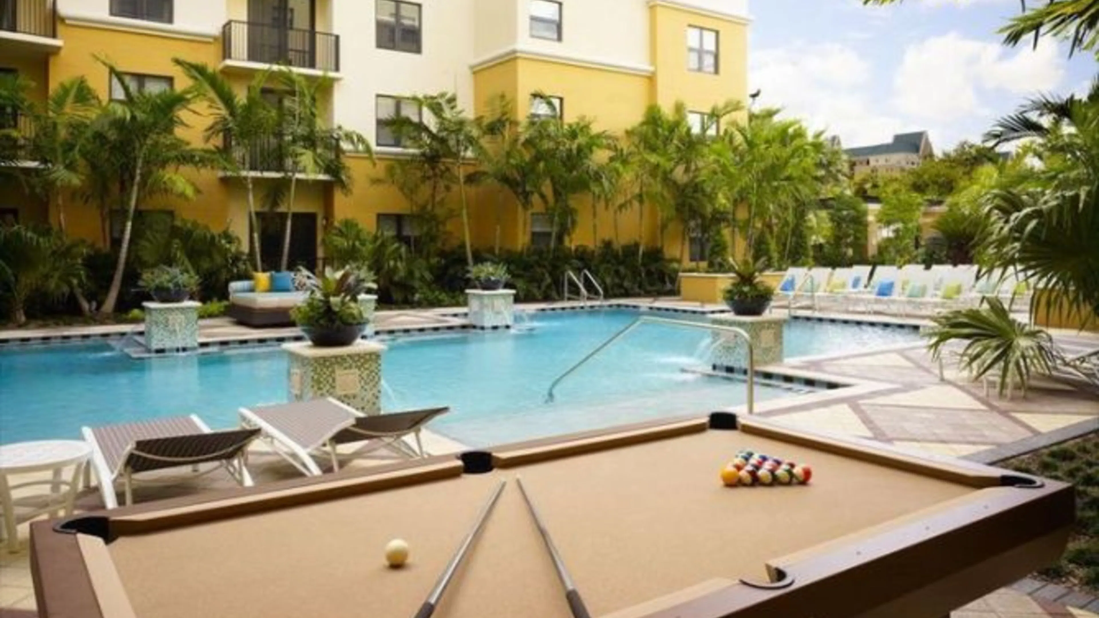 AMLI Flagler Village luxury apartment grounds outdoor pool table