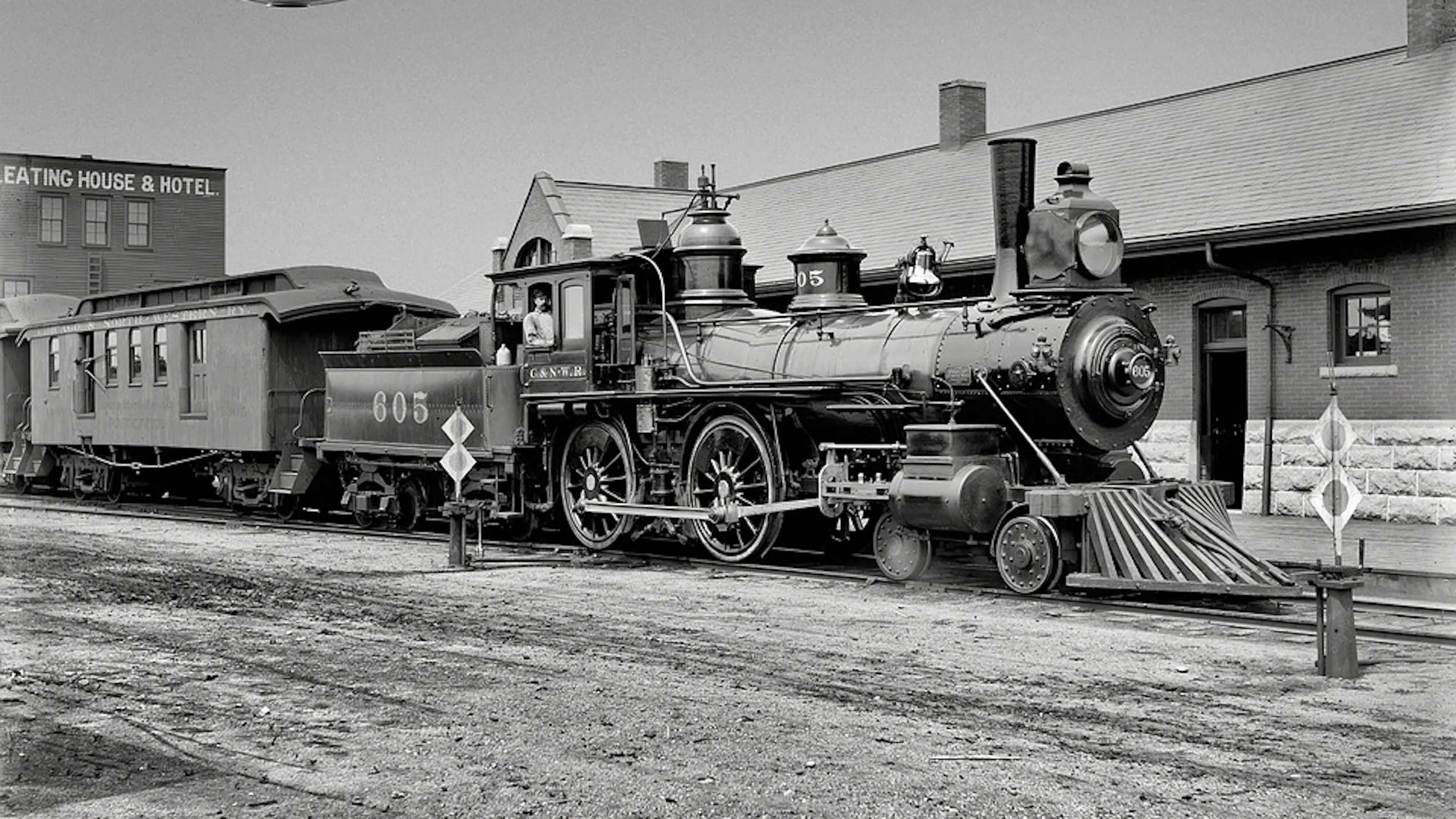 An old locomotive pictured in black and white with the number 605 printed in large letters on the side