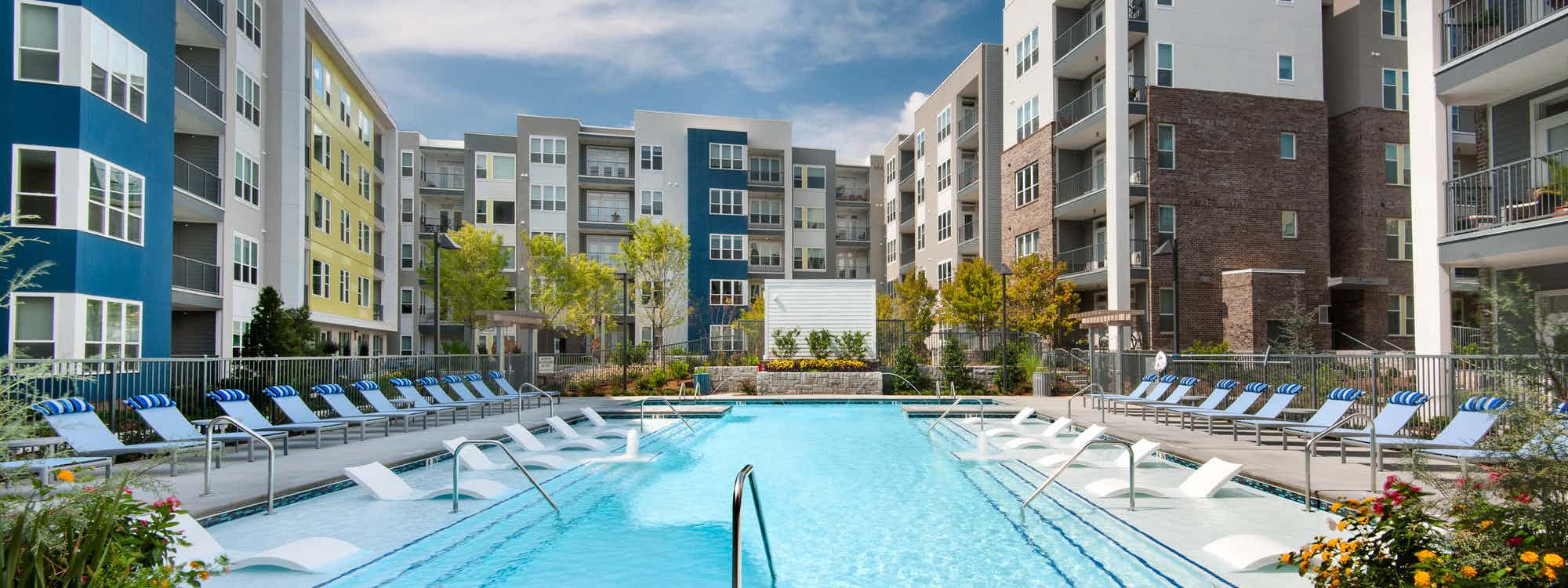 Exterior view of the courtyard and pool at AMLI Piedmont Heights planted with lush trees and landscaping