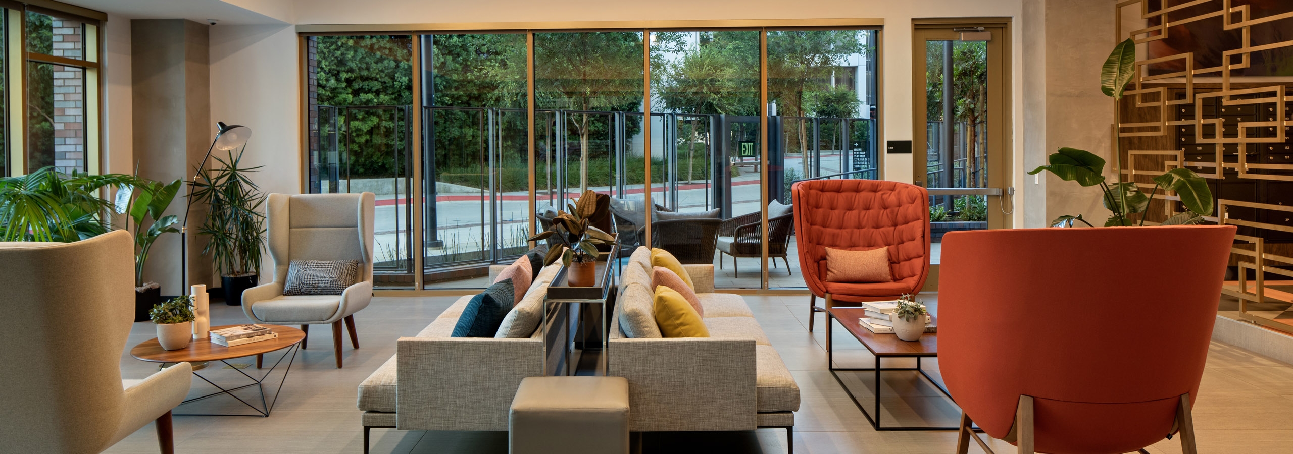 Dusk view of stylish java bar lounge with modern seating and decorative gold partition wall at AMLI Old Pasadena apartments