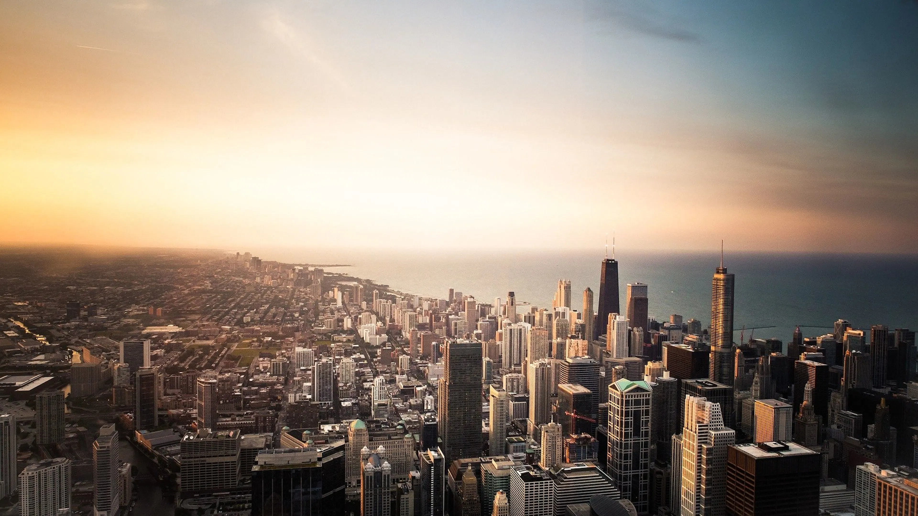 The Chicago skyline stretching north into the distance with the sunset illuminating all the windows on the skyscrapers