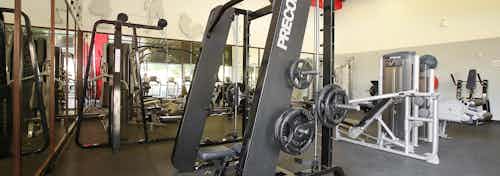 Interior daytime close-up of workout facility at AMLI Warner Center apartment building with strength equipment and yoga balls