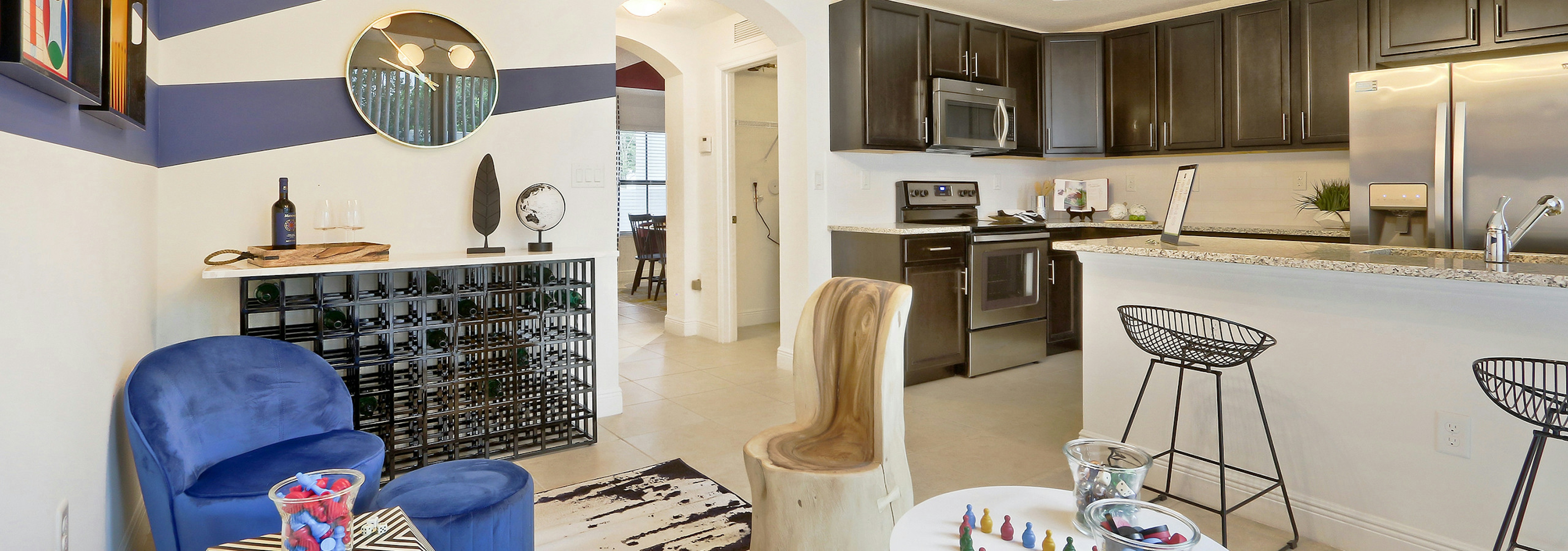 AMLI Toscana Place Townhouse dining area, island kitchen with stools, granite counters and stainless steel appliances