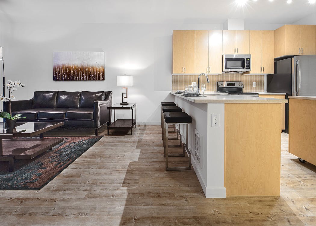 Interior AMLI Wallingford apartment living room with kitchen with large white counter space