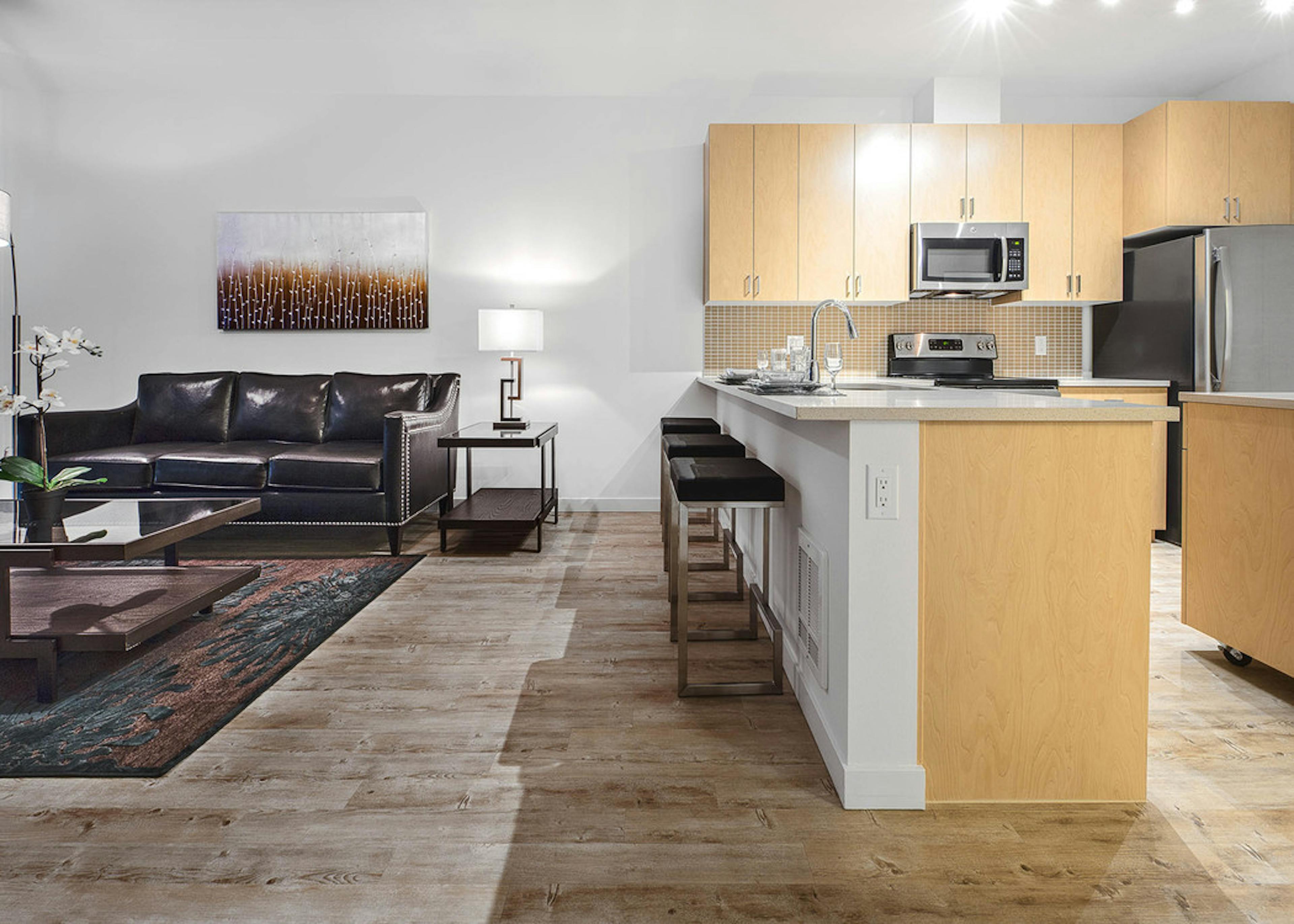 Interior AMLI Wallingford apartment living room with kitchen with large white counter space