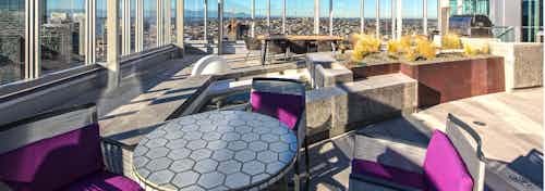 Exterior deck of AMLI Arc with seating and barbeque grill and views of Downtown Seattle