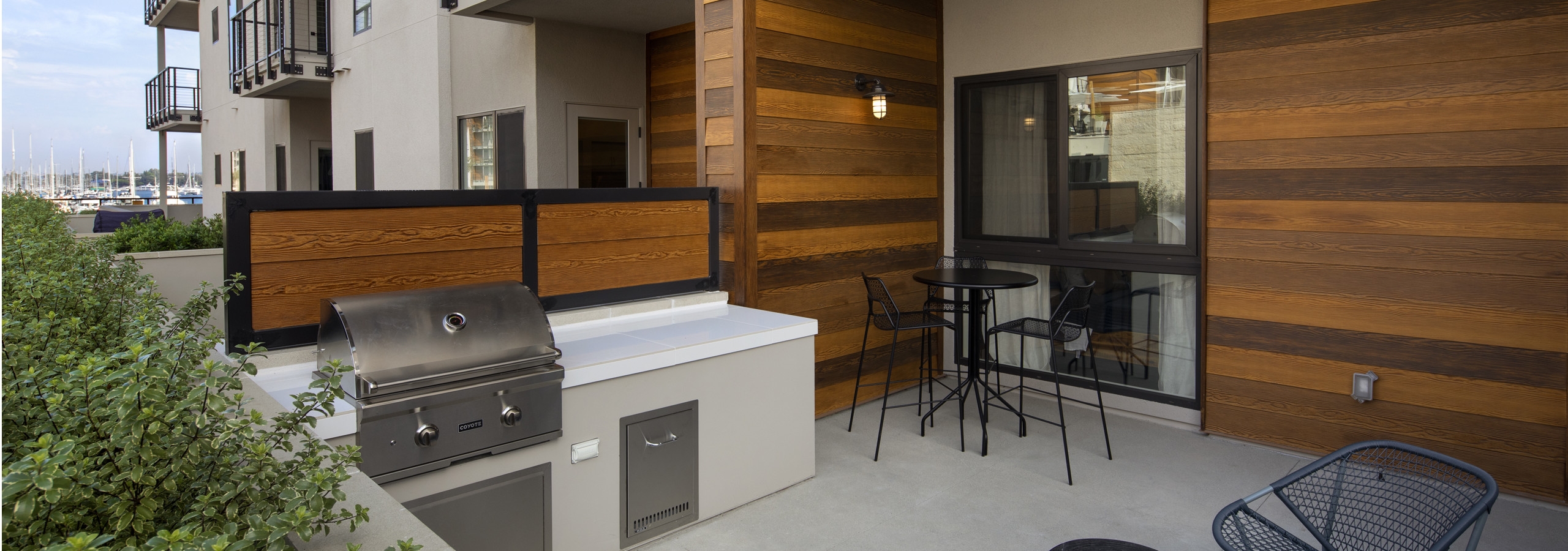 Daytime exterior view of large private patio with wood paneling, attached grilling station at AMLI Marina Del Rey apartments