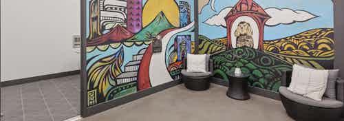 AMLI Old 4th Ward paw wash area with new dog colorful mural with seating before rounding the corner to the dog tubs