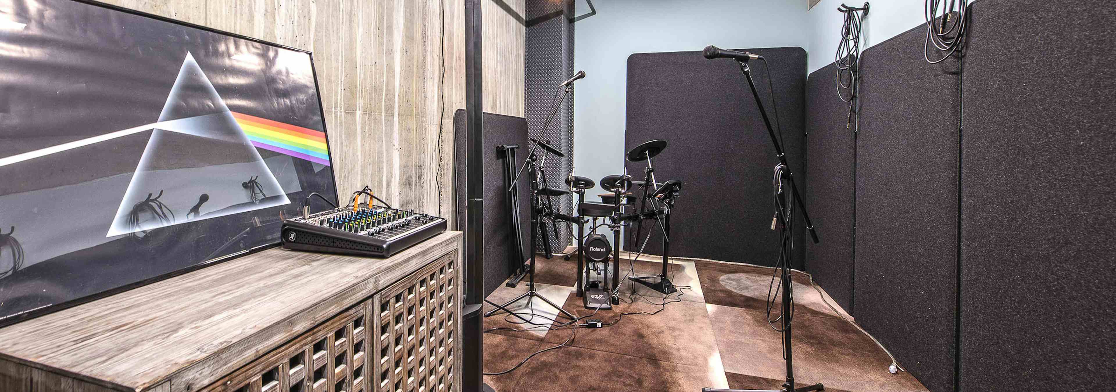 Interior music room of AMLI Arc with music soundboard microphones small electric drum set and sound proof room