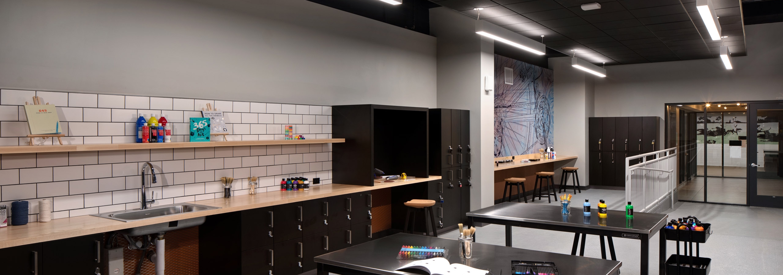 AMLI Old Pasadena apartments makers lab with sink and ample workspaces with barstool seating and lockers