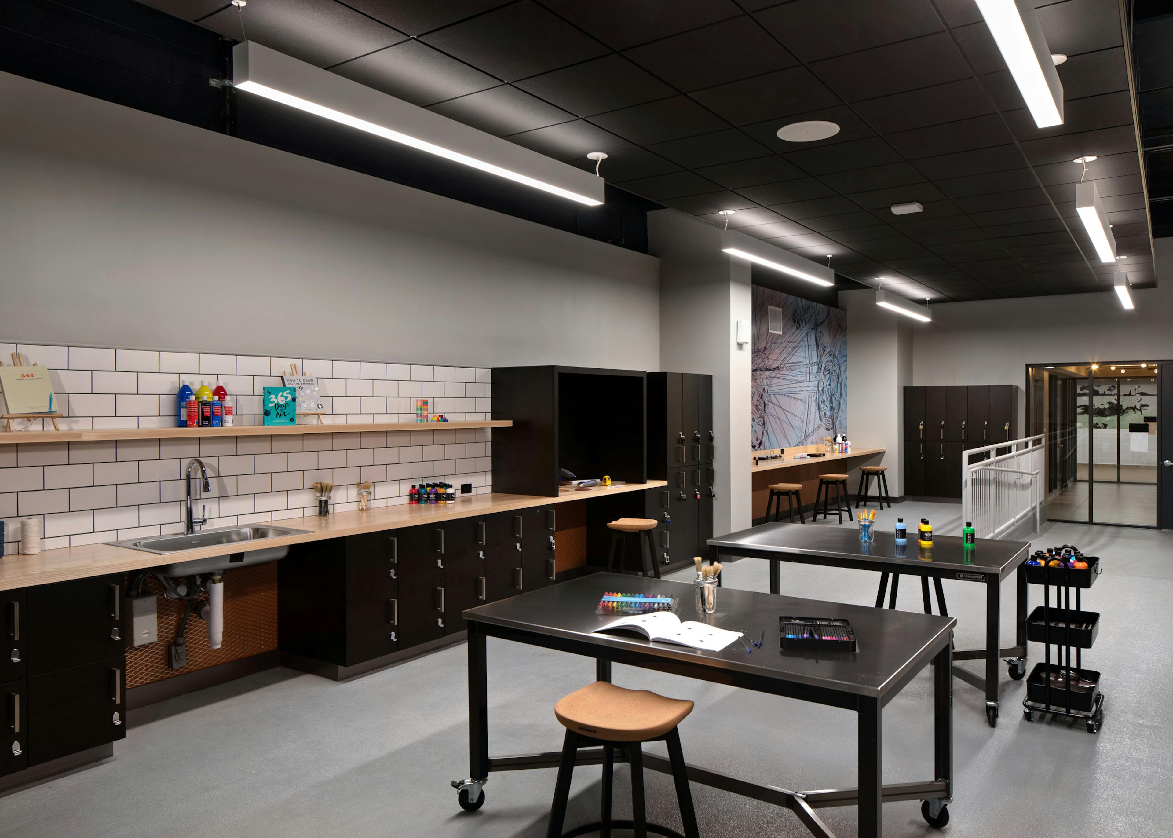 AMLI Old Pasadena apartments makers lab with sink and ample workspaces with barstool seating and lockers 