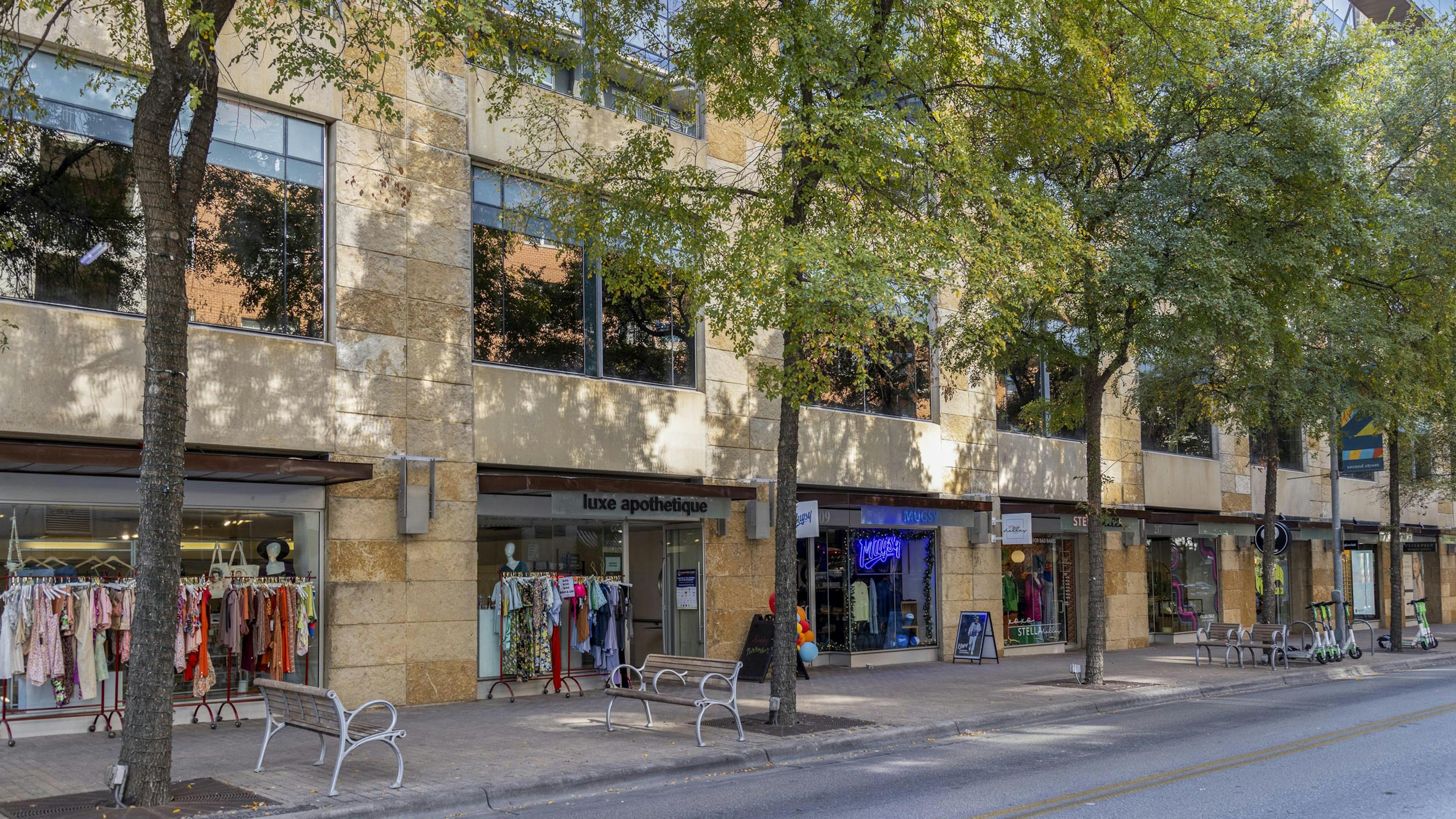 Austin 2nd Street District retailers including clothing stores with racks of colorful clothing outside their entrances