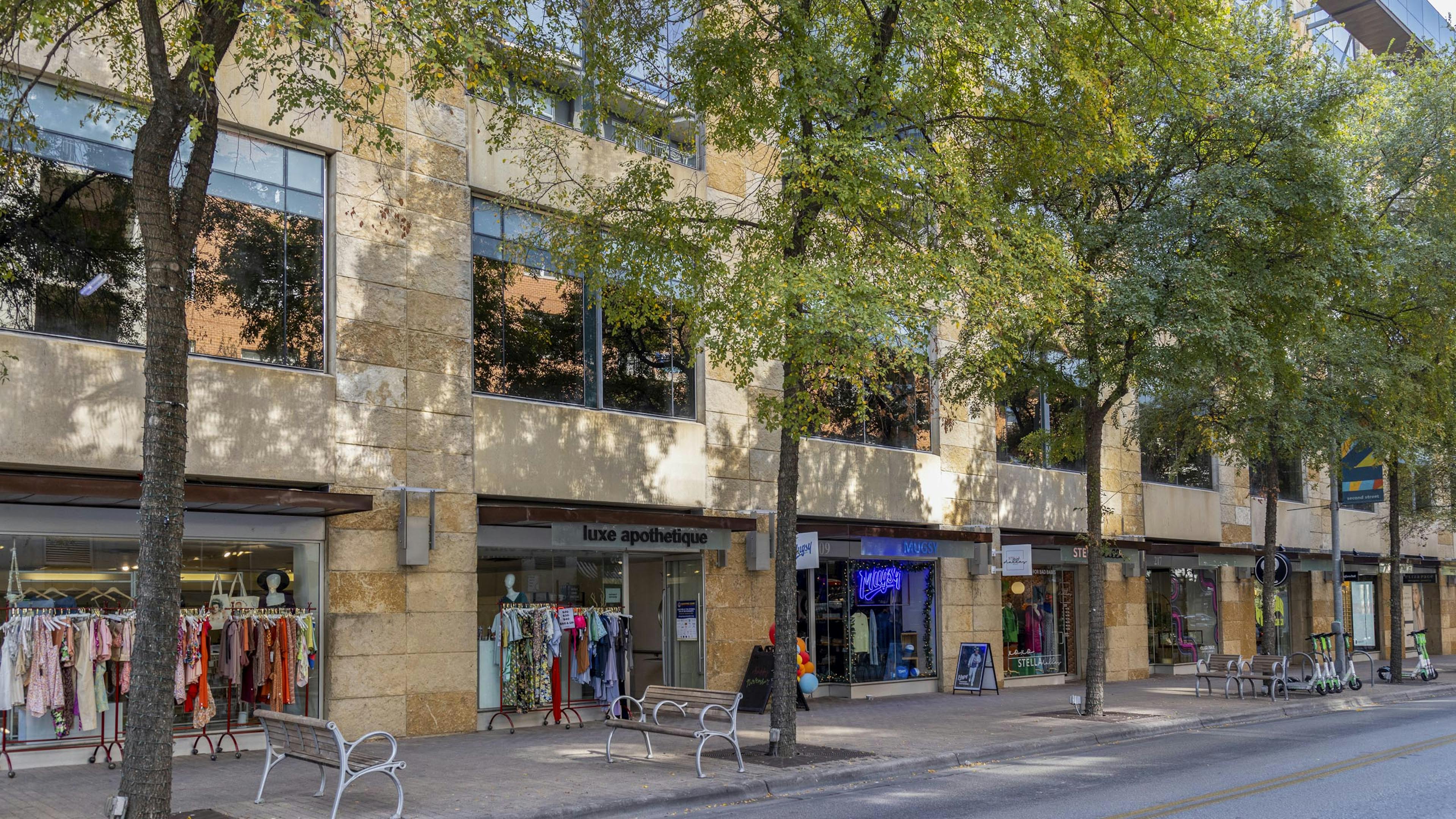 Austin 2nd Street District retailers including clothing stores with racks of colorful clothing outside their entrances