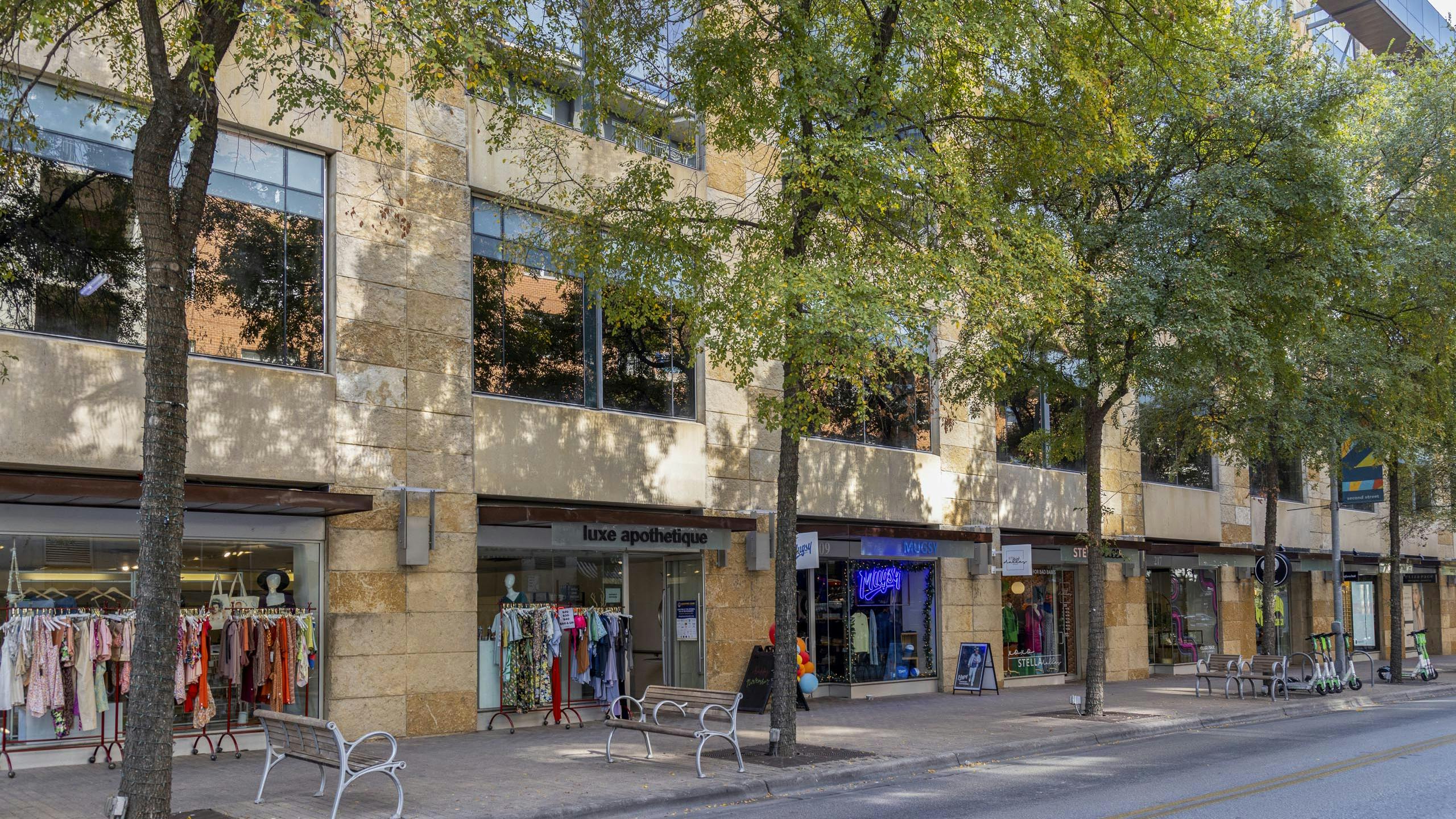 Austin 2nd Street District retailers including clothing stores with racks of colorful clothing outside their entrances