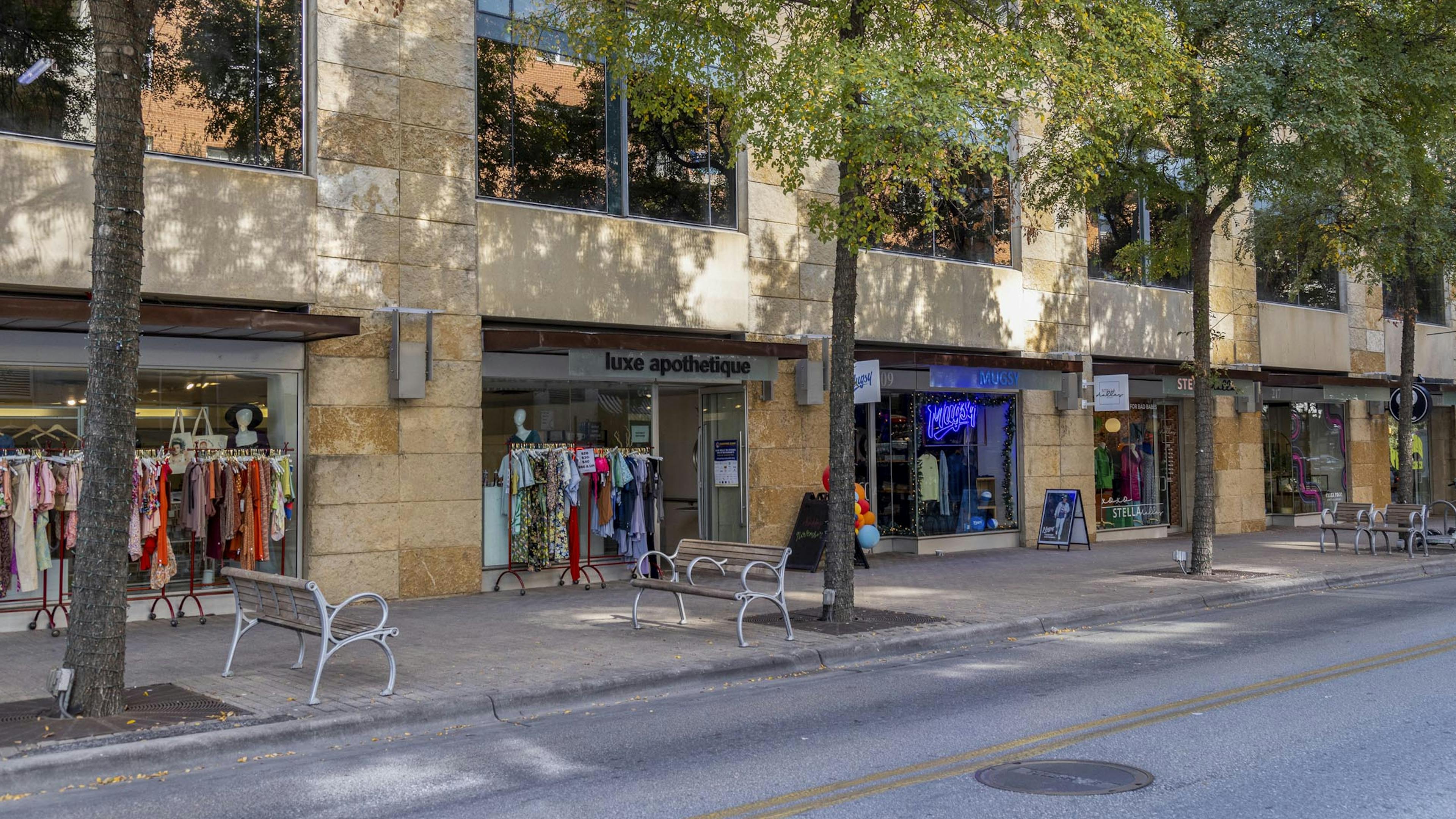 Austin 2nd Street District retailers including clothing stores with racks of colorful clothing outside their entrances