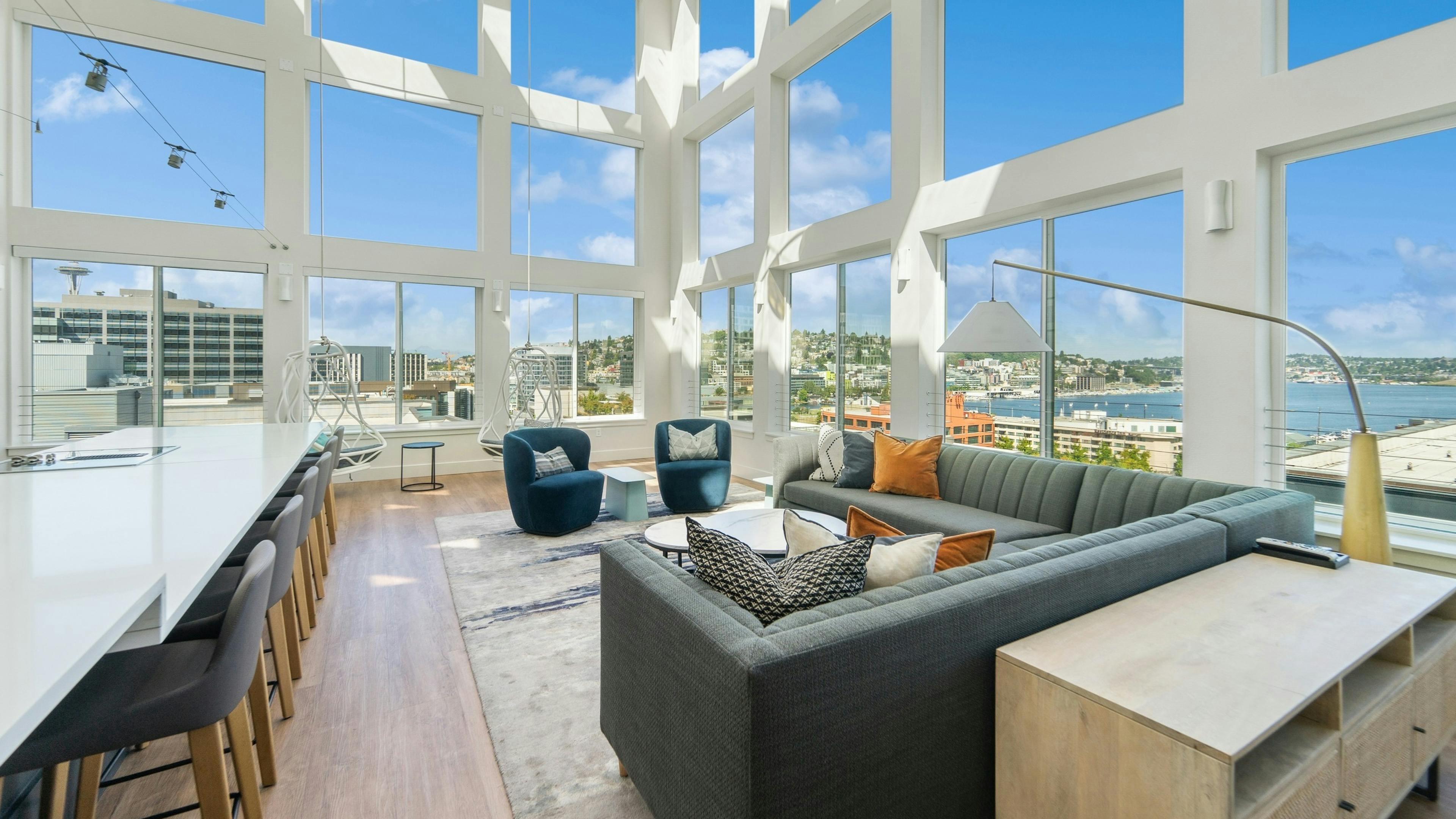 Solarium at AMLI South Lake Union with high ceilings and huge windows with scenic views and seating areas and a long island