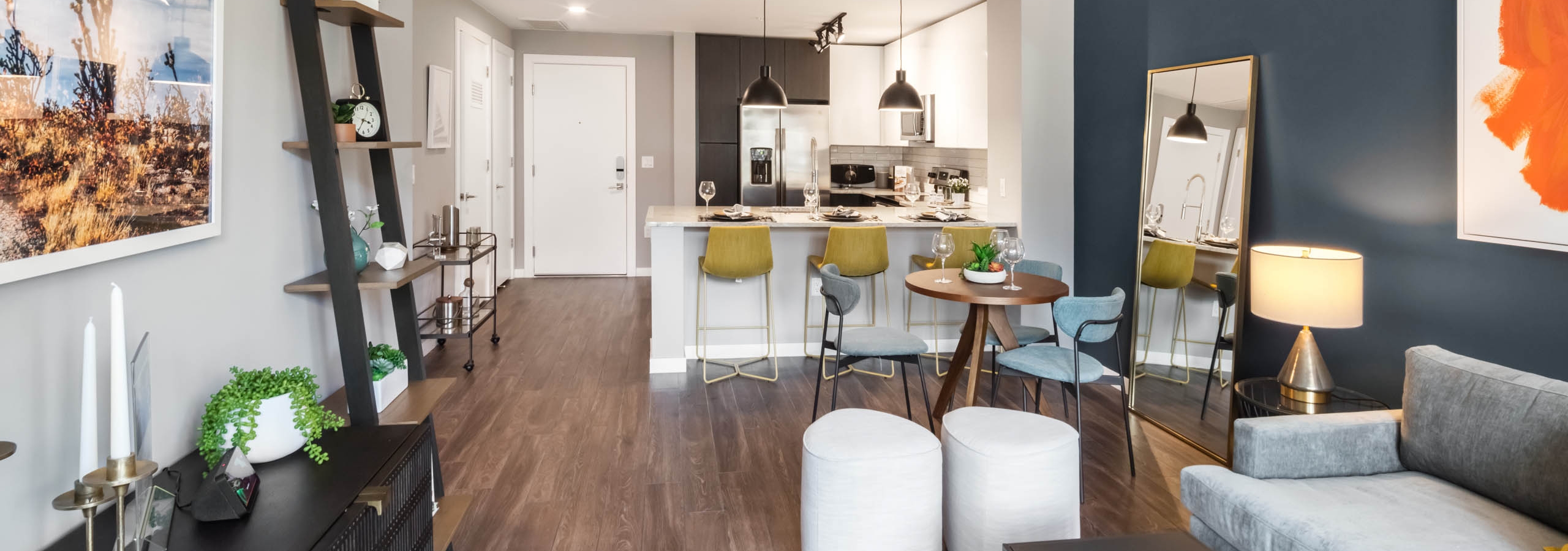 Close up view of modern vanity in an AMLI at Uptown apartment bathroom with view of spacious walk in closet in background