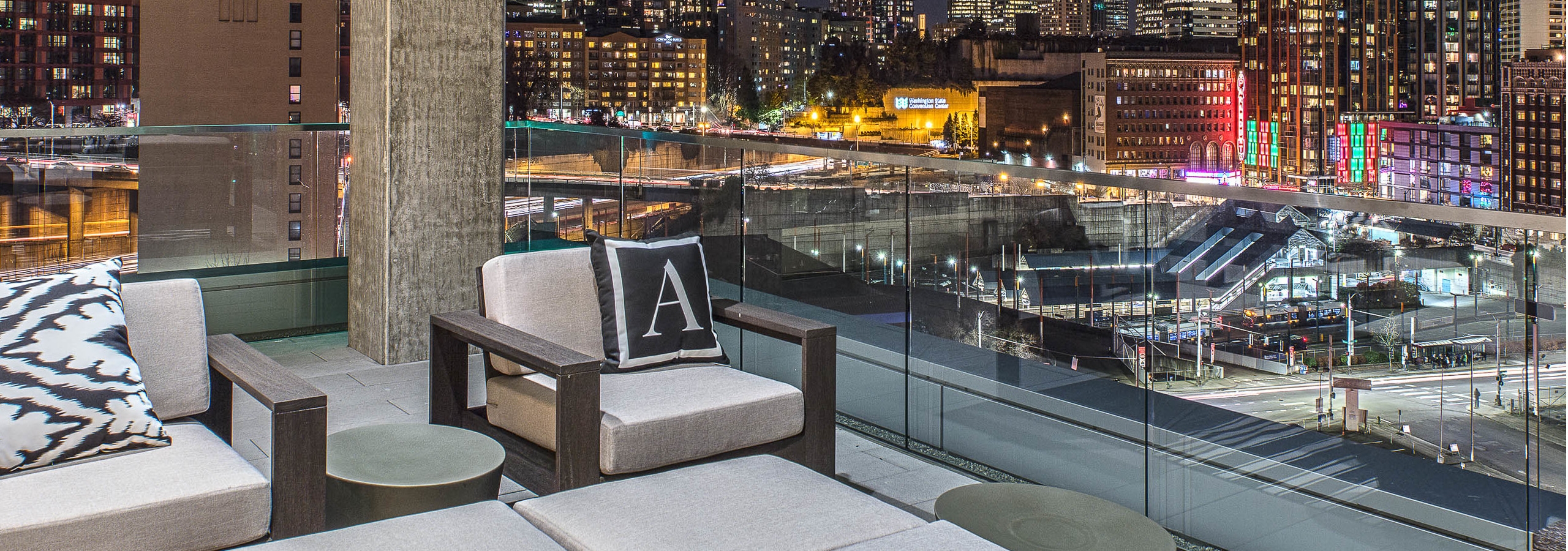 Exterior deck of AMLI Arc with seating and views of Downtown Seattle