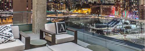 Exterior deck of AMLI Arc with seating and views of Downtown Seattle