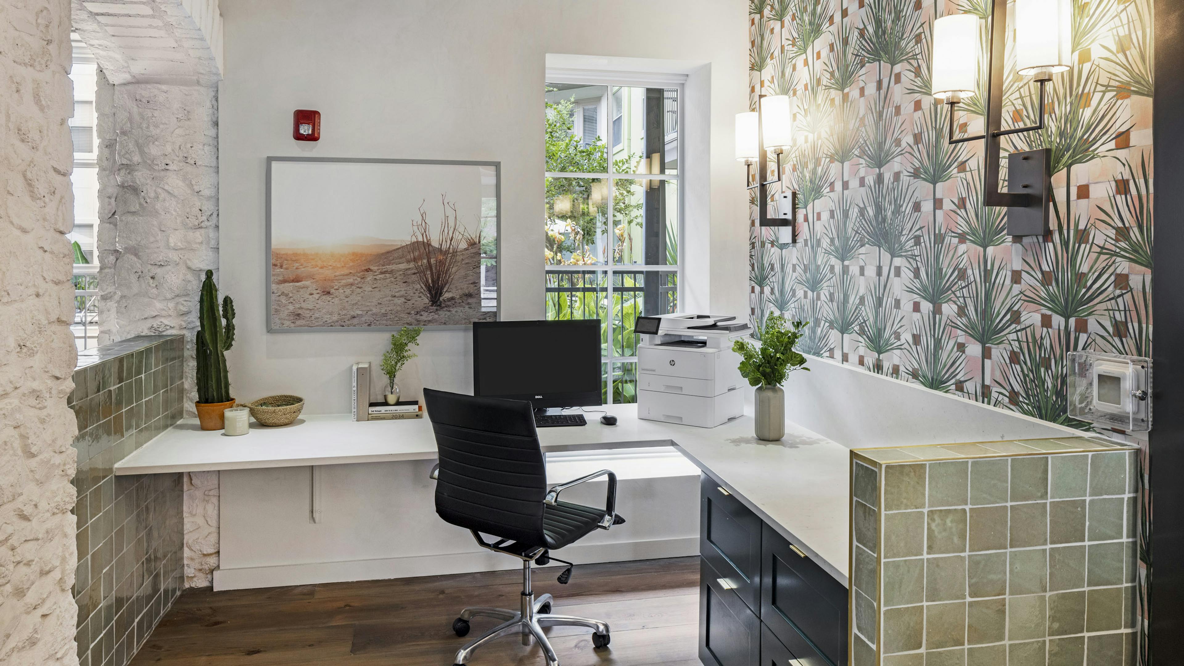 AMLI 300 business center with white corner desk with computer and printer with green tile detailing and patterned wallpaper