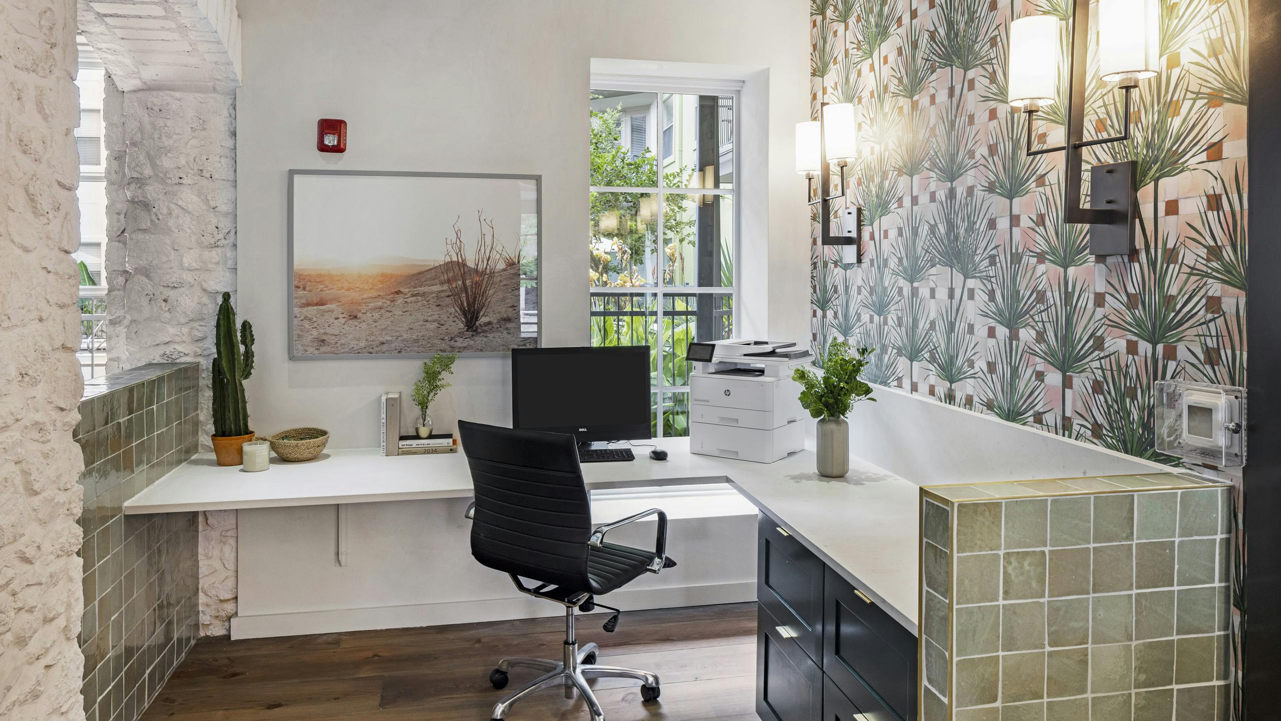 AMLI 300 business center with white corner desk with computer and printer with green tile detailing and patterned wallpaper