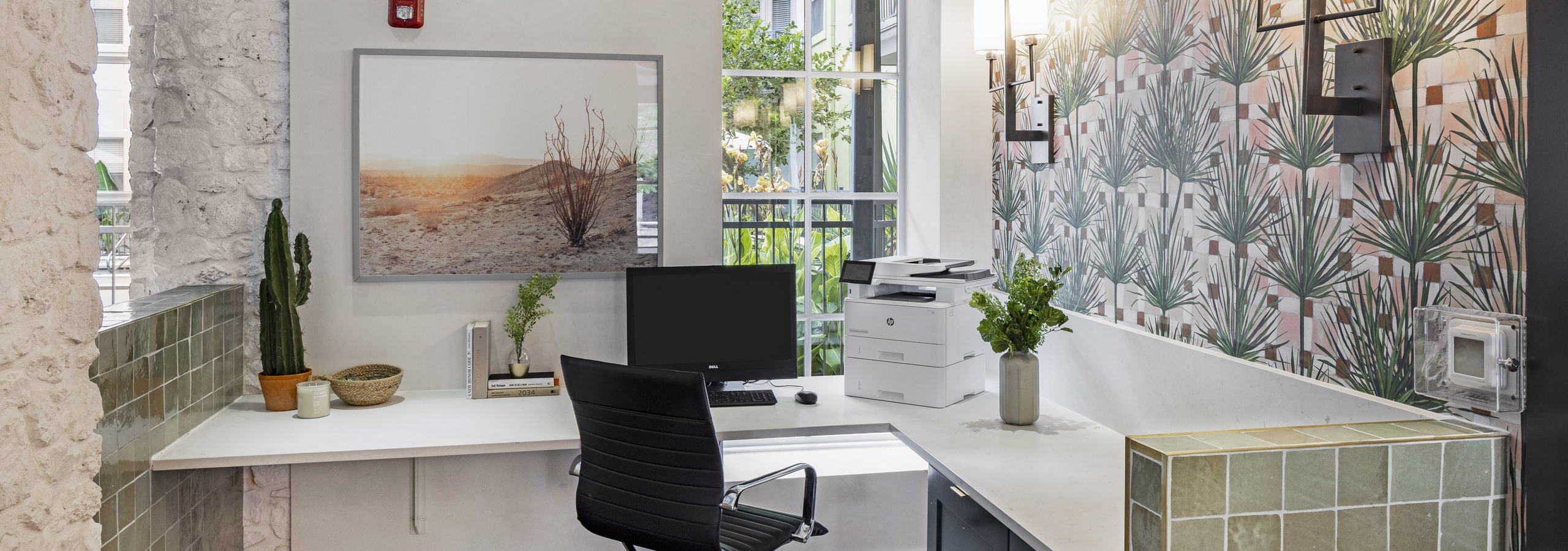 AMLI 300 business center with white corner desk with computer and printer with green tile detailing and patterned wallpaper