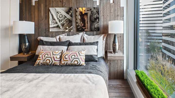 Interior view of apartment of AMLI Arc of bedroom with white walls and large window
