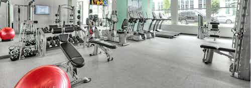 Interior of the fitness center at AMLI South Lake Union with treadmills and weight machines and free weights