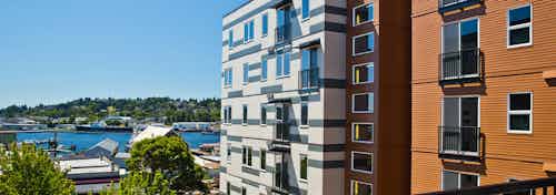 Sunny daytime exterior view from an apartment at AMLI Mark24 facing Market Street that overlooks Salmon Bay and docked boats