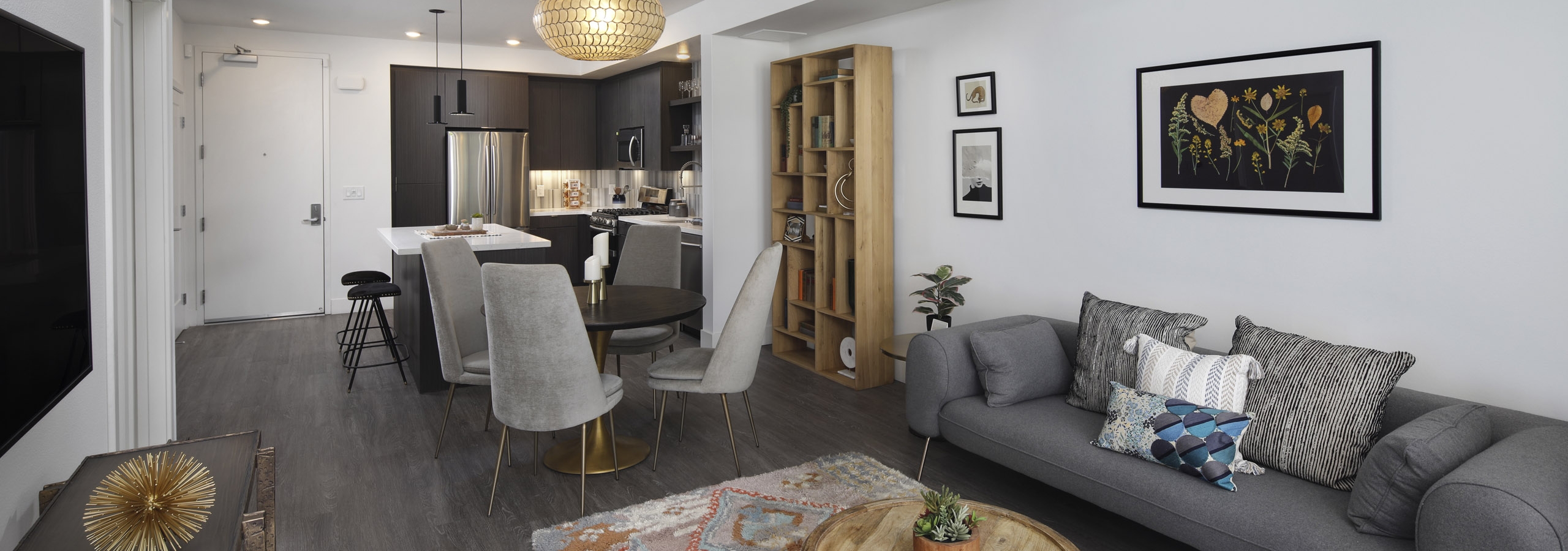 AMLI Park Broadway furnished apartment with gray hard wood floors throughout living room and kitchen and gray furniture