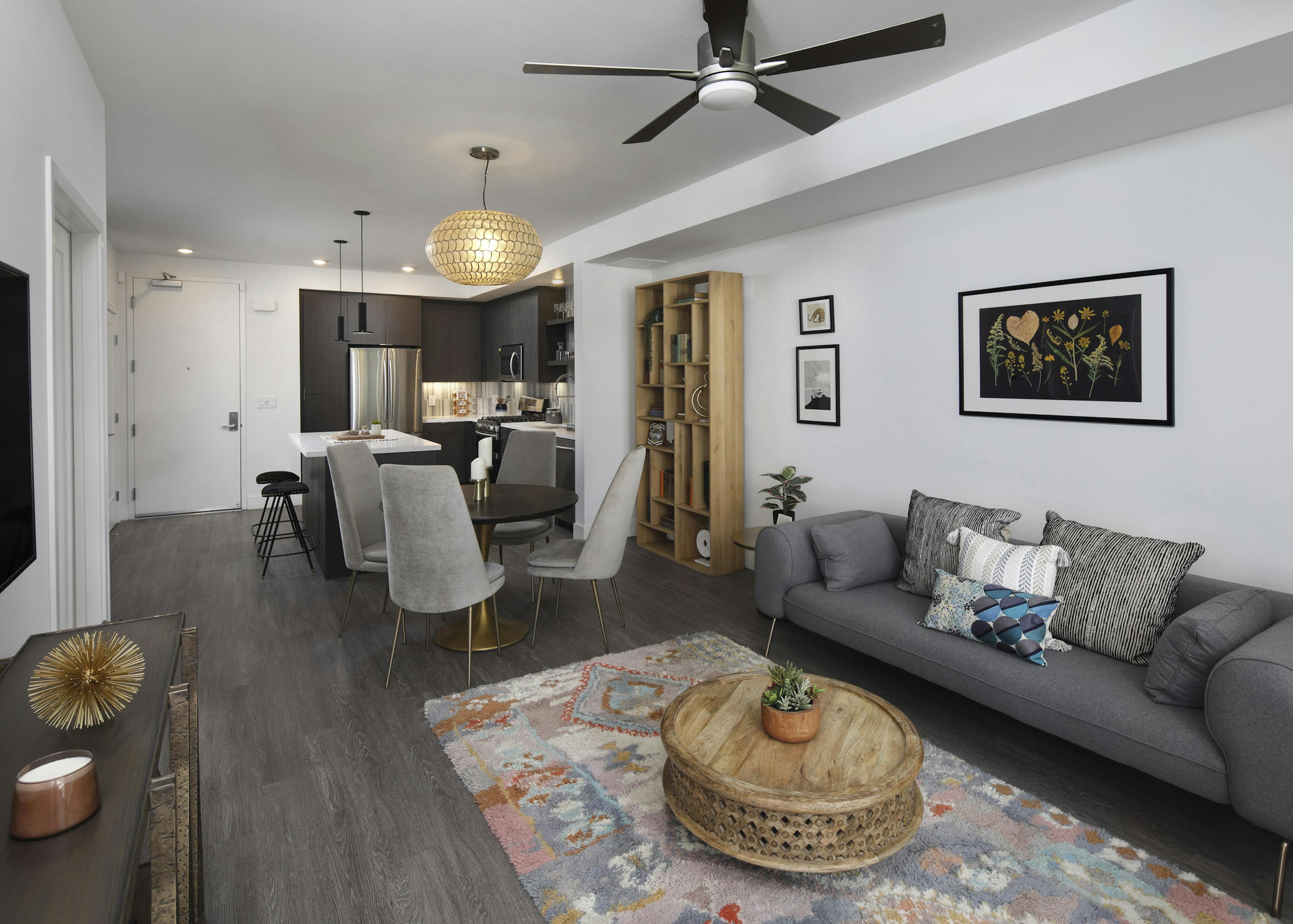 AMLI Park Broadway furnished apartment with gray hard wood floors throughout living room and kitchen and gray furniture