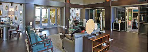 AMLI Warner Center apartment leasing office interior with stylish décor, two leasing stations and comfortable seating area